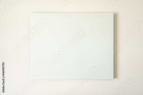 Empty canvas, poster, blank frame canvas, mock up, on a white wall, living room, home decoration template, front view © Jon Ortiz