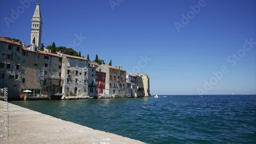 Old town walls and the seafront surrounding by sea. View of the typical croatian old houses in the coastline of Rovinj
