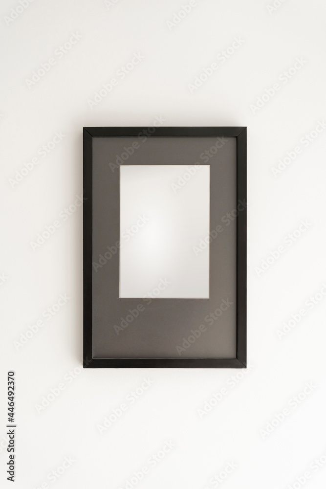 Interior decoration, empty black frame, poster white canvas mock up on a white wall, living room, template front view