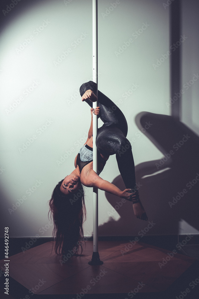 young asian woman doing pole dance at home young asian woman doing pole dance at home