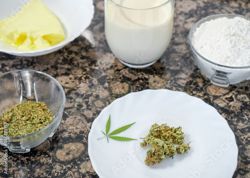 Cooking with marijuana. Close up of cannabis buds and other ingredients prepared for cooking a sweet dessert.
