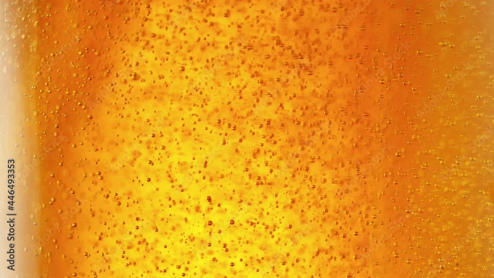 Super slow motion of macro shot of beer drink, close-up. Filmed on high speed cinema camera, 500 fps.