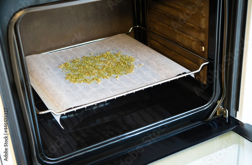 Cooking with marijuana. Baking cannabis buds to activate psychoactive effect and cook with it later. photo