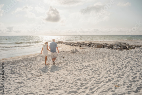 holding hands along the beach