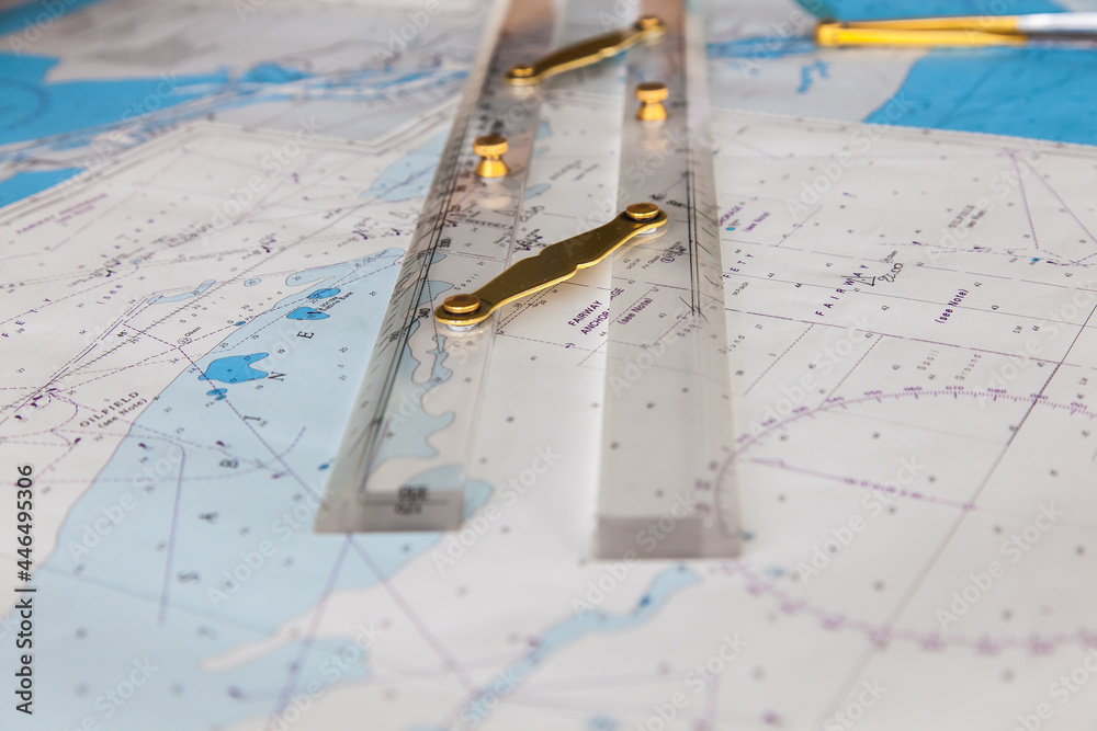 Maps of the ship and on them a ruler and divider for plotting the ...