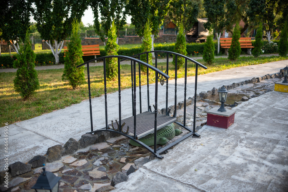 a small black metal bridge with horseshoes