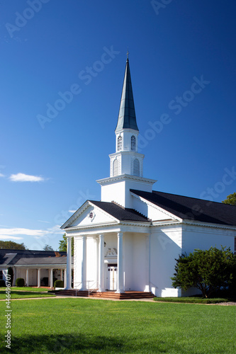 Fotobehang White traditional church with tall steeple