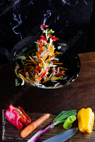 Sauteed colorful vegetables, rustic pan. bell pepper, carrot, onion. fajitas