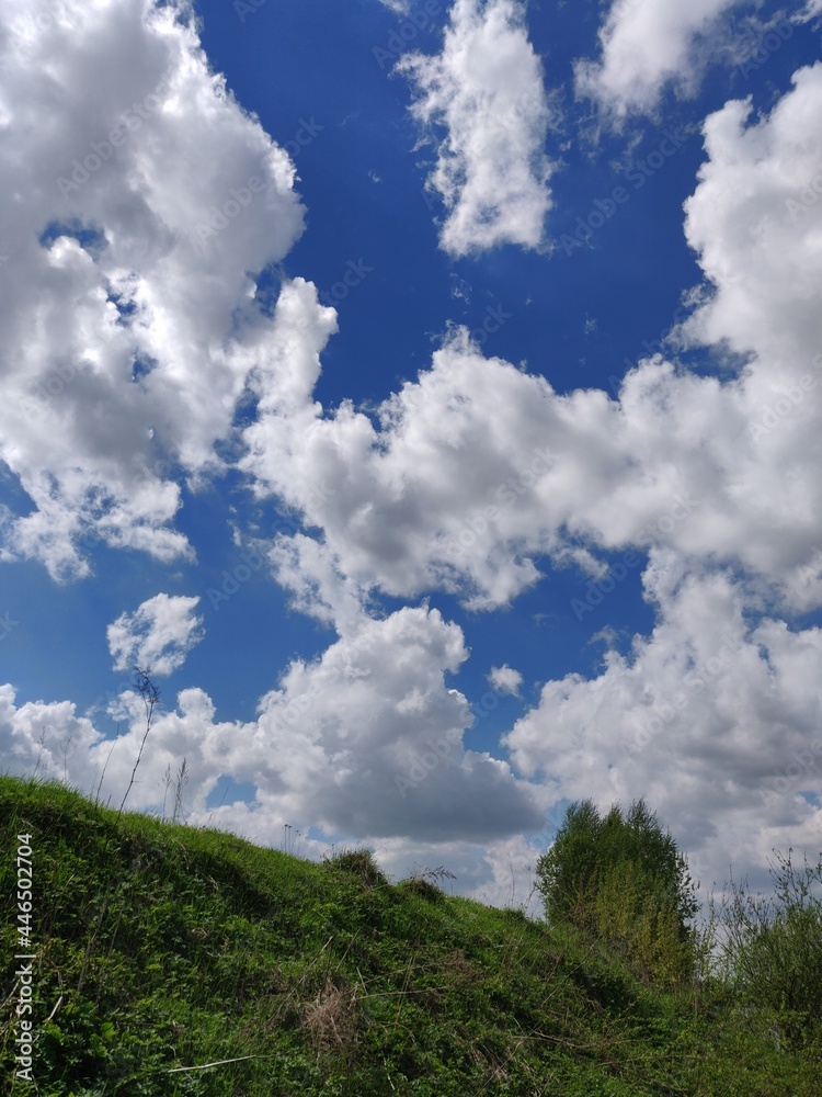 blue sky, clouds over the hill and forest