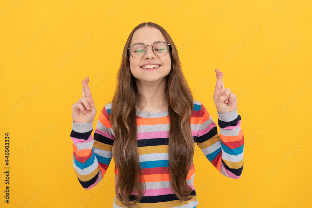 smiling dreamy schoolgirl nerd kid in eyeglasses for vision crossed fingers making wish, dream smiling dreamy schoolgirl nerd kid in eyeglasses for vision crossed fingers making wish, dream