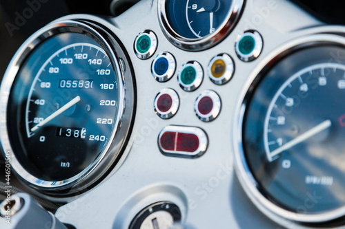 Dashboard of a sports motorcycle, with speedometer and tachometer, close up.
