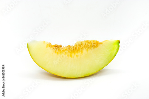 Piece of ripe melon with seeds on white background