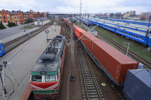 Passenger train parked at the train station top view. Locomotive and freight train.