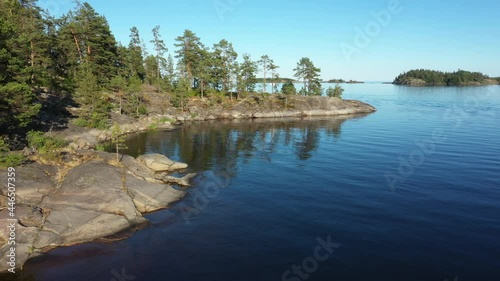 Aerial view on the lake and Islands with rocky coastline and forest in Karelia. Drone view on the beautiful Ladoga lake. Skerriy in the northwestern part of the Lake Ladoga photo