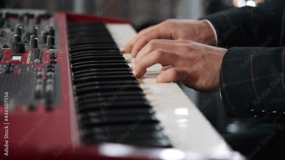 a man plays a synthesizer at a party in a fancy suit a man plays a synthesizer at a party in a fancy suit