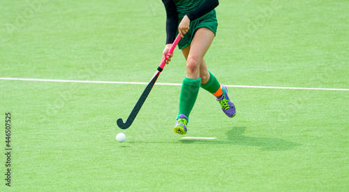 Young hockey player woman with ball in attack playing field hockey game. Horizontal sport poster, greeting cards, headers, website