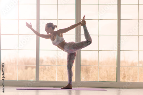 Fototapeta Naklejka Na Ścianę i Meble -  Health concept. Young beautiful woman does yoga exercise in the modern room