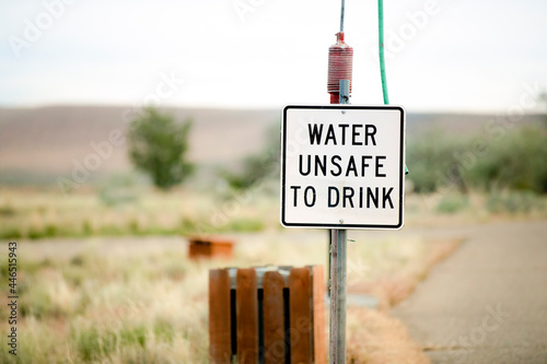 faded water unsafe to drink sign at a camp site