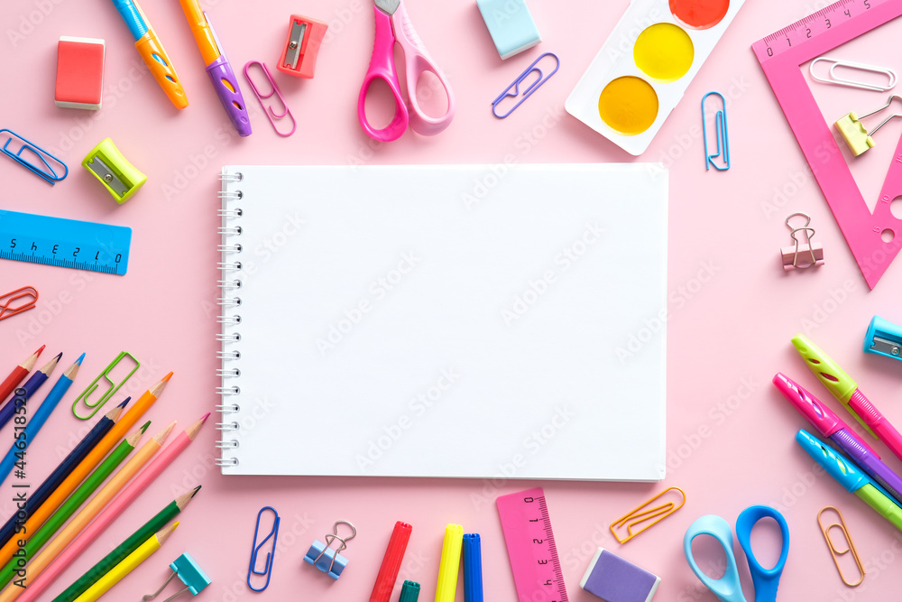 School supplies and paper notepad on pink background. Back to school concept. Flat lay, top view, copy space. School supplies and paper notepad on pink background. Back to school concept. Flat lay, top view, copy space.