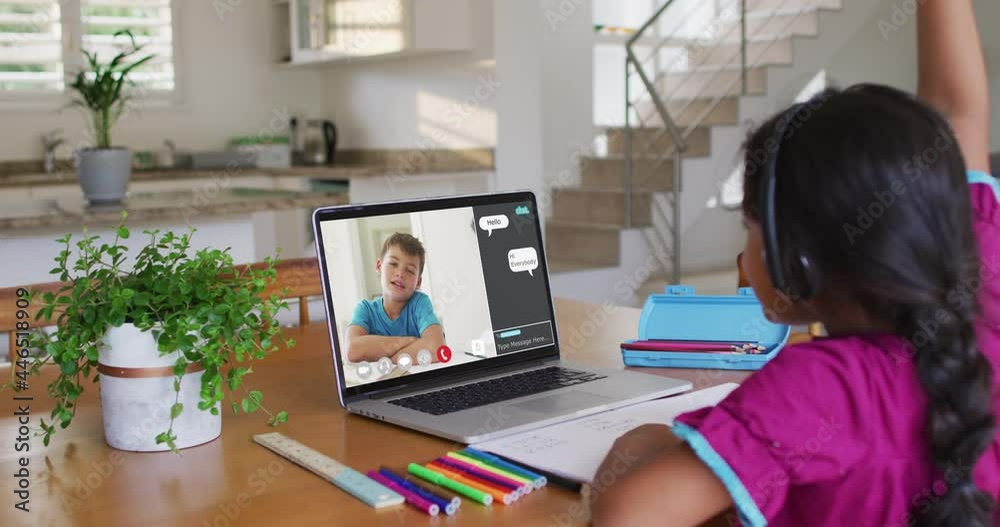 Schoolgirl using laptop for online lesson at home, with schoolboy and web chat on screen Schoolgirl using laptop for online lesson at home, with schoolboy and web chat on screen