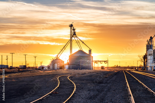 Grain silo and railroad tracks sunset