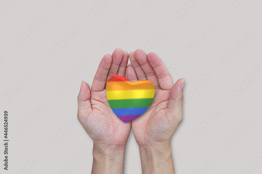 LGBTQ rainbow heart in hands on white background. Diverse equality freedom of Love. LGBTQ rainbow heart in hands on white background. Diverse equality freedom of Love.