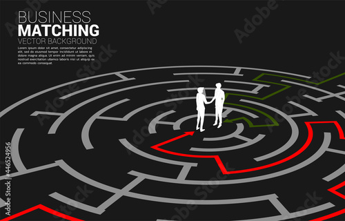 Silhouette of businessman handshake in the maze. Concept of business matching. Team work partnership and cooperation.
