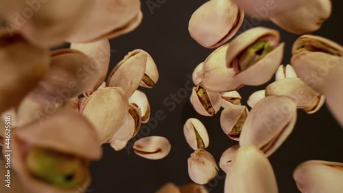 Super Slow Motion Shot of Fresh Roasted Pistachio Nuts Flying Towards Camera at 1000 fps.