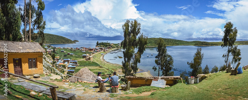 Photos Two men sitting and enjoying the landscape in a lodging in middle of nature on the top of the Island of the Sun