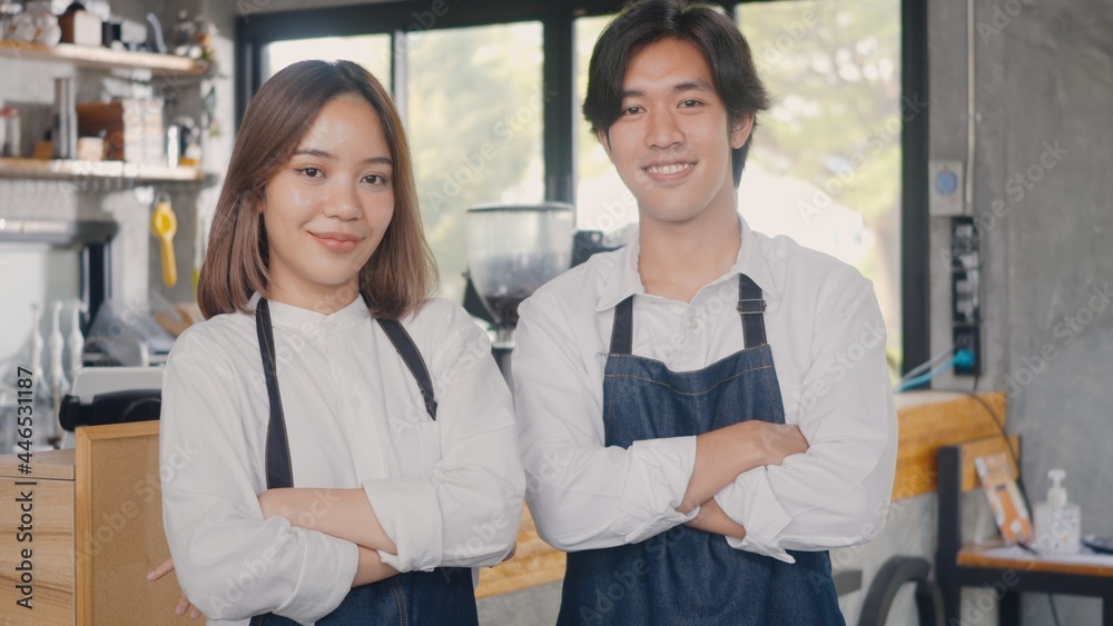 Fototapeta premium Portrait of happy handsome young man and beautiful woman confident cafe owner standing crossed arms on front counter bar together at the cafe coffee shop, Owner small business concept