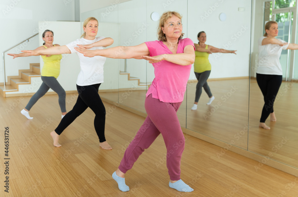 Three European mature women are dancing in fitness room