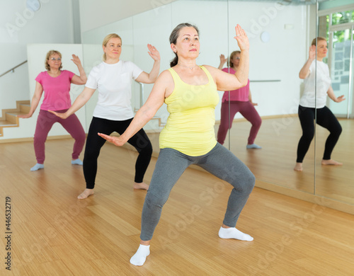 Mature women dancing aerobics at lesson in the dance class