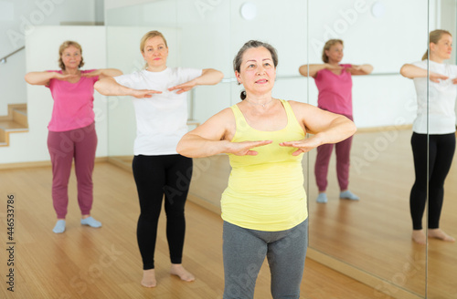 Happy adults training swing steps at dance class