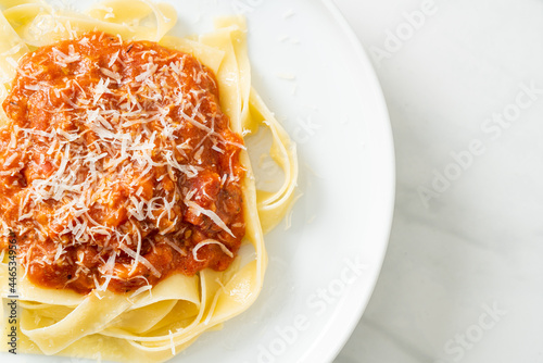 pork bolognese fettuccine pasta with parmesan cheese