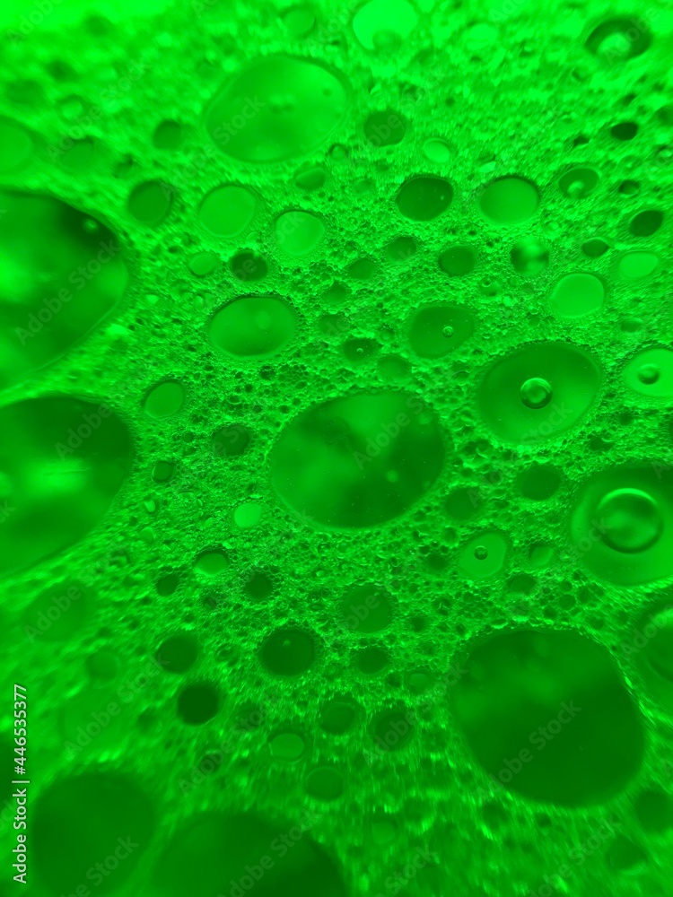 Green water drops. Bubbles background. Oil macro photography. 