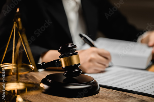 Law firm office, Selective focus judges gavel, businesswoman or female lawyer making contract paper with law book,.scales of justice, document legal, justice advice service concept.