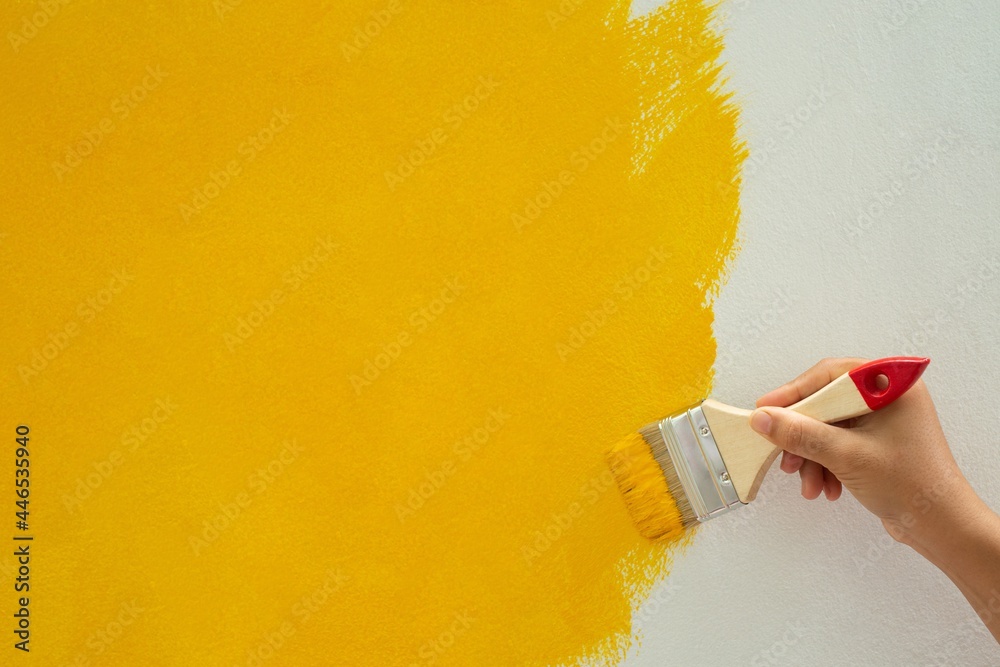 Do-it-yourself yellow paint plots on the walls of the house - obrazy, fototapety, plakaty 
