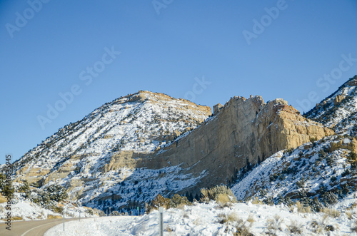 Winter in the American Southwest. Snow Covered Redrock Cliffs Driving Tourism