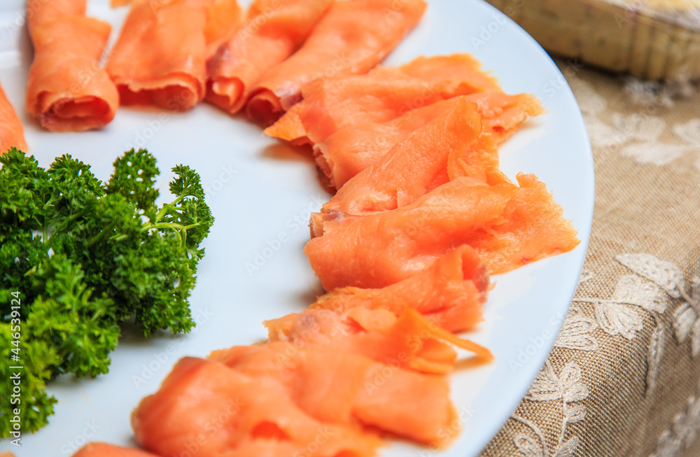 Salmon Carpaccio served in a white dish Salmon Carpaccio served in a white dish