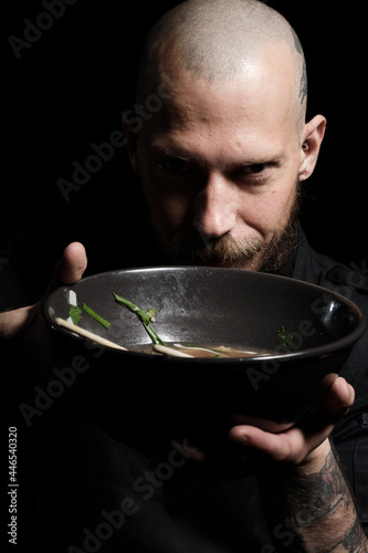 Chef tasting freshly made dish, smelling it