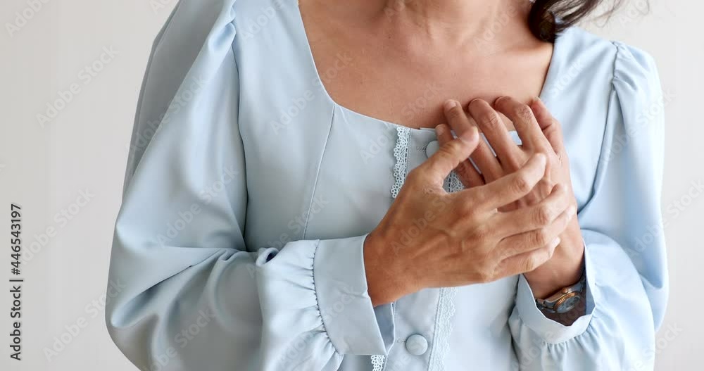 A senior woman suffered and pain from heart attack desease using hand holding chest on heart position. Concept of older person health care.