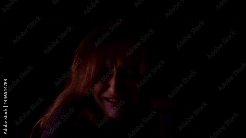 Schizophrenia. The young woman suffers from a mental illness, schizophrenia. She has fears and feels shattered. She screams in terror in the flashing light. Schizophrenia. The young woman suffers from a mental illness, schizophrenia. She has fears and feels shattered. She screams in terror in the flashing light.