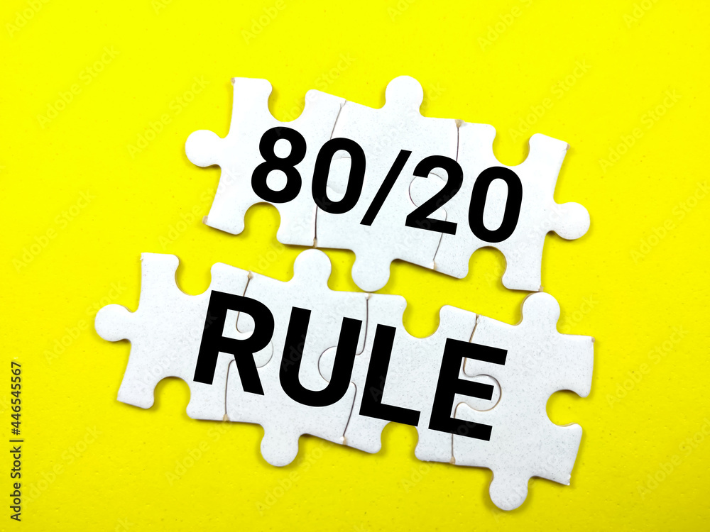 Business and finance concept.Text 80/20 RULE writing on jigsaw puzzle on a yellow background. Business and finance concept.Text 80/20 RULE writing on jigsaw puzzle on a yellow background.