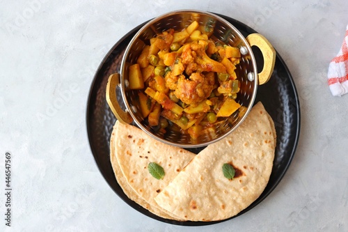 Aloo Gobi Mutter curry, cauliflower, and peas curry. Aloo Gobi masala. Served with wheat roti. famous Indian curry dish with potatoes and green peas. Copy space photo