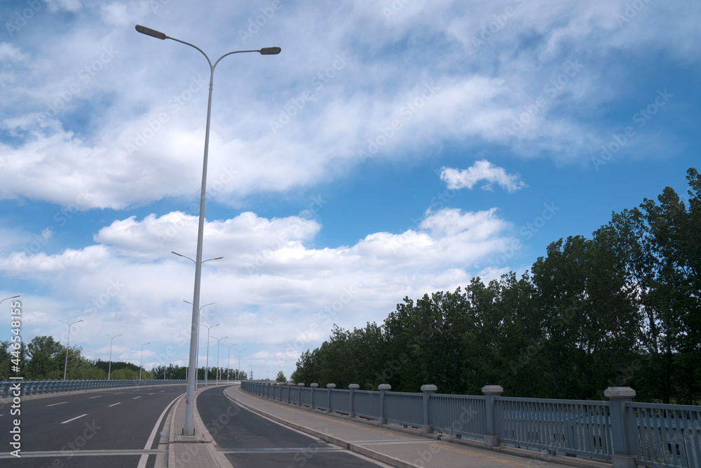Unmanned highway under blue sky and white clouds