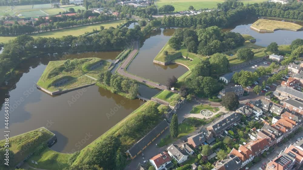 Aerial of traffic driving over small bridge in a beautiful, green landscape in the Netherlands Aerial of traffic driving over small bridge in a beautiful, green landscape in the Netherlands