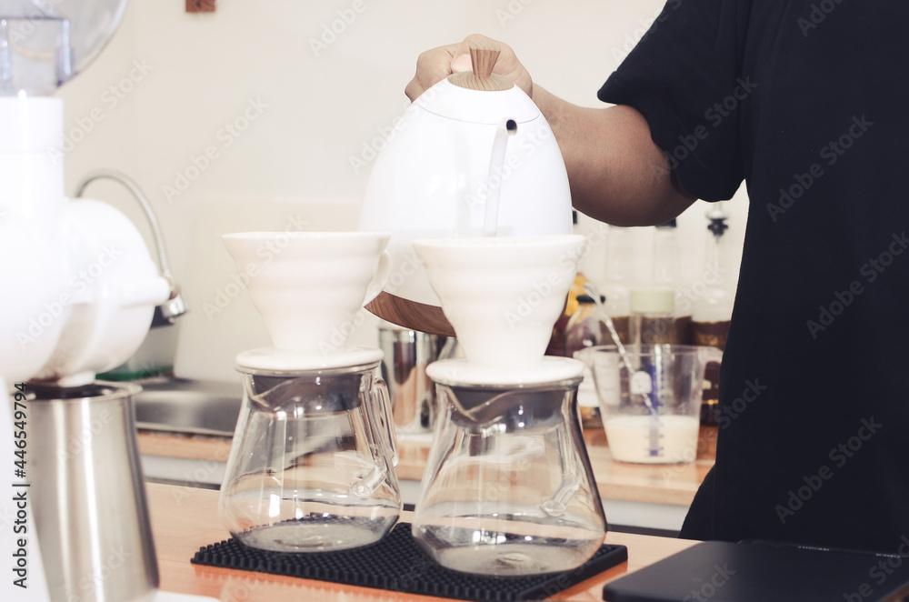 Making pour over coffee with hot water being poured from a kettle Making pour over coffee with hot water being poured from a kettle