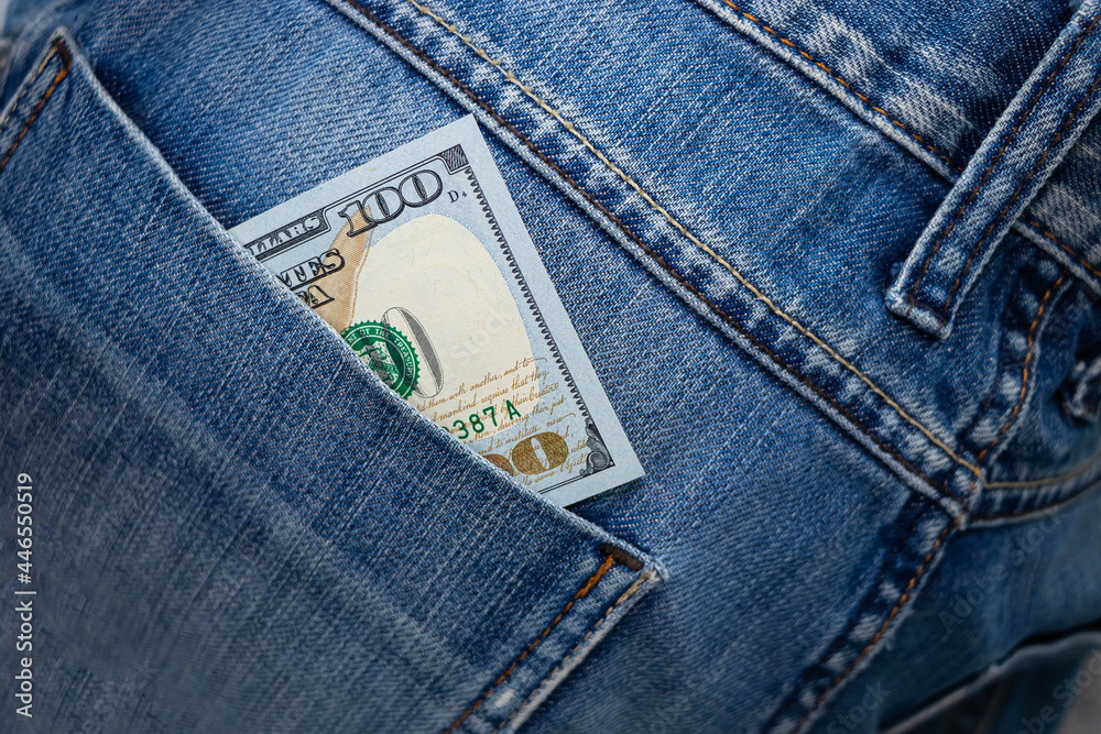 Dollar bill in the back pocket of jeans. hundred bucks in a denim pocket. Dollar bill in the back pocket of jeans. hundred bucks in a denim pocket.