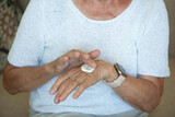 Senior women apply hand cream on her hands. Close up.