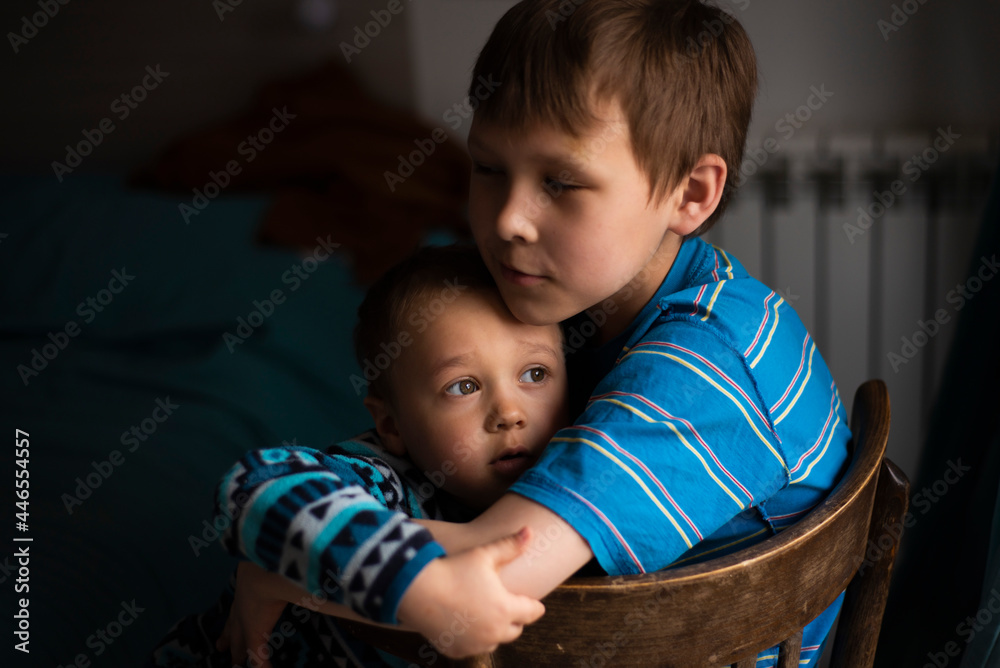 Portrait of two serious sad boys, sitting by the window. Selective Focus  Stock Photo | Adobe Stock